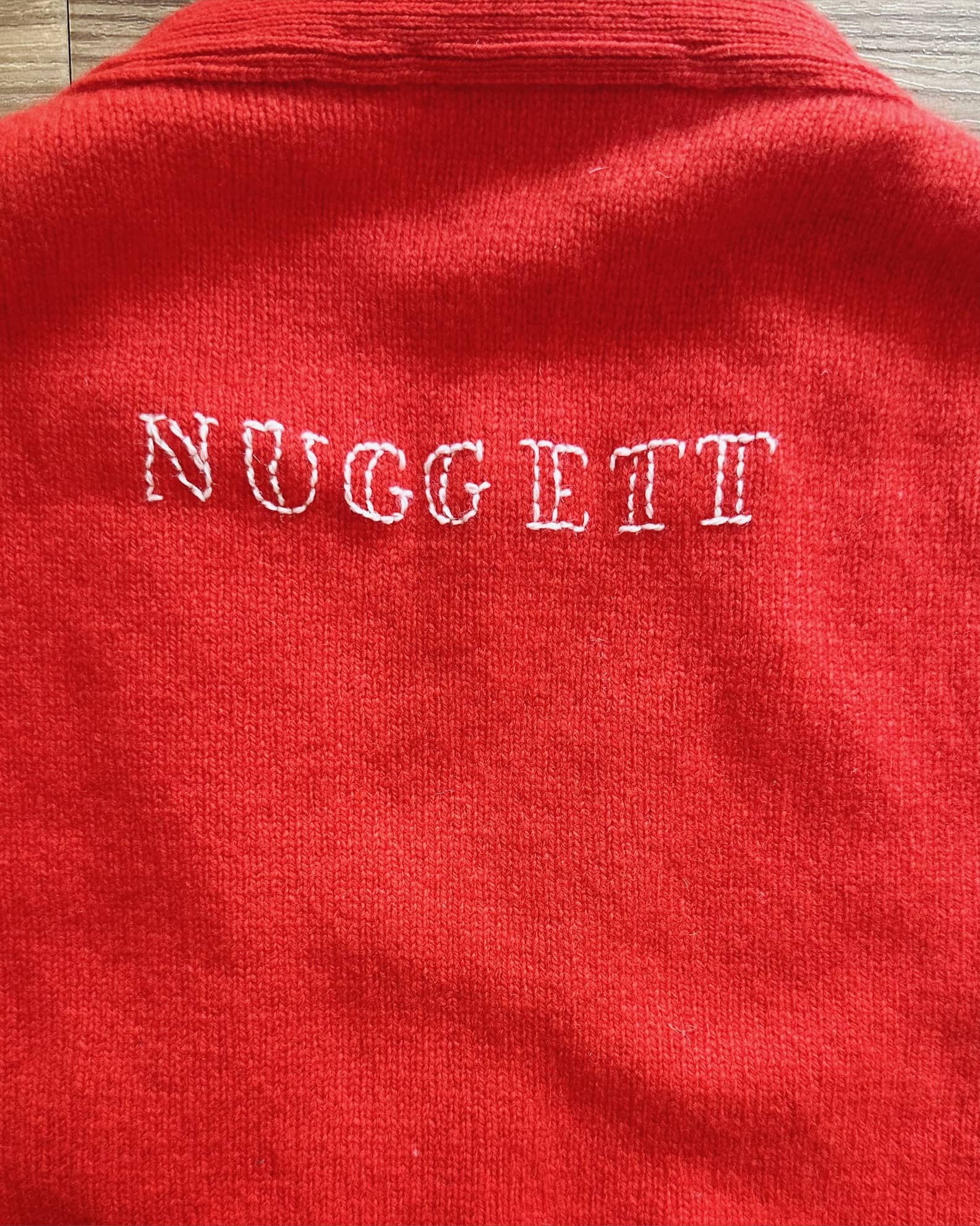 Embroidered lettering on knitwear.