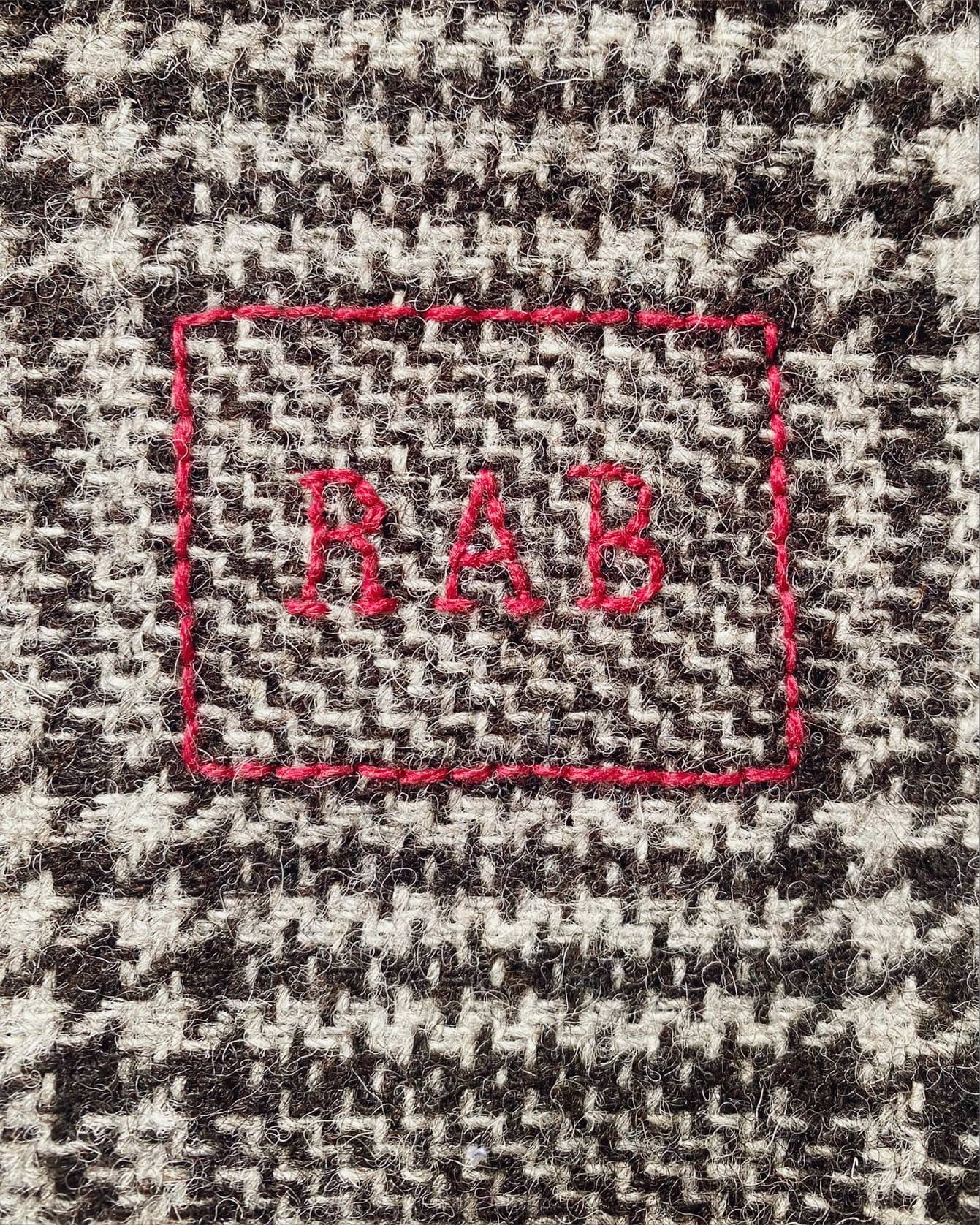 Monogram in rectangle.